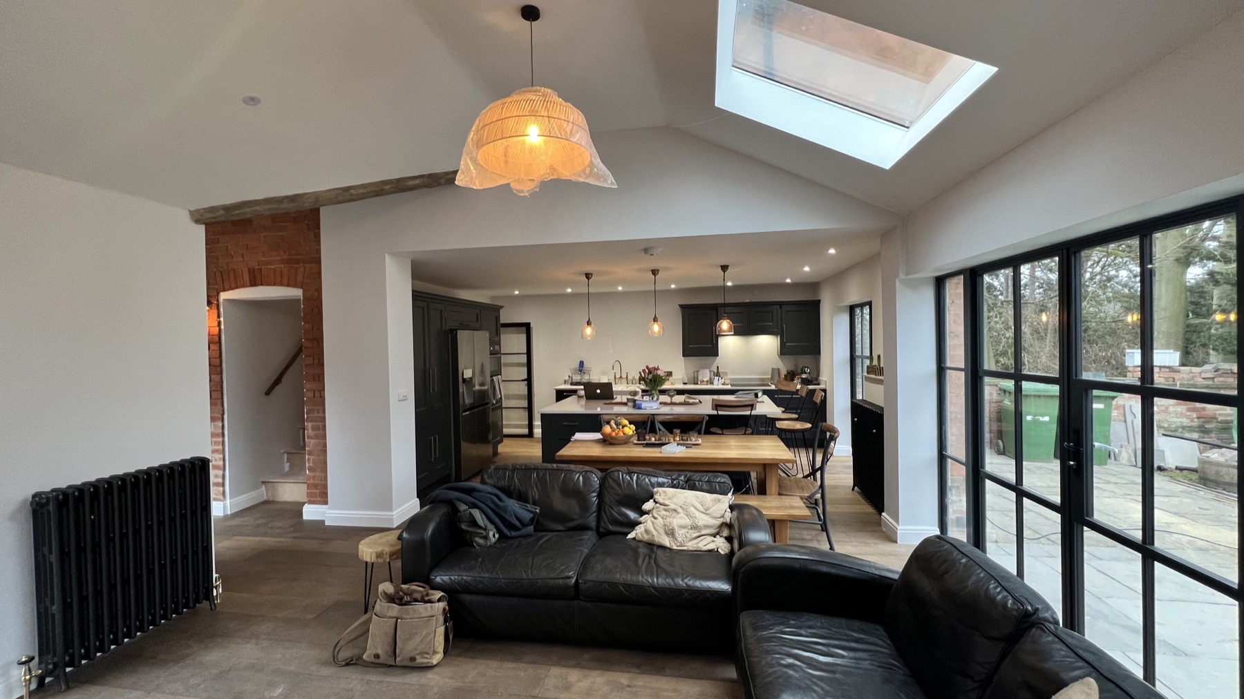 Kitchen, dining and family spaces connected beneath rooflights at Eastgate House