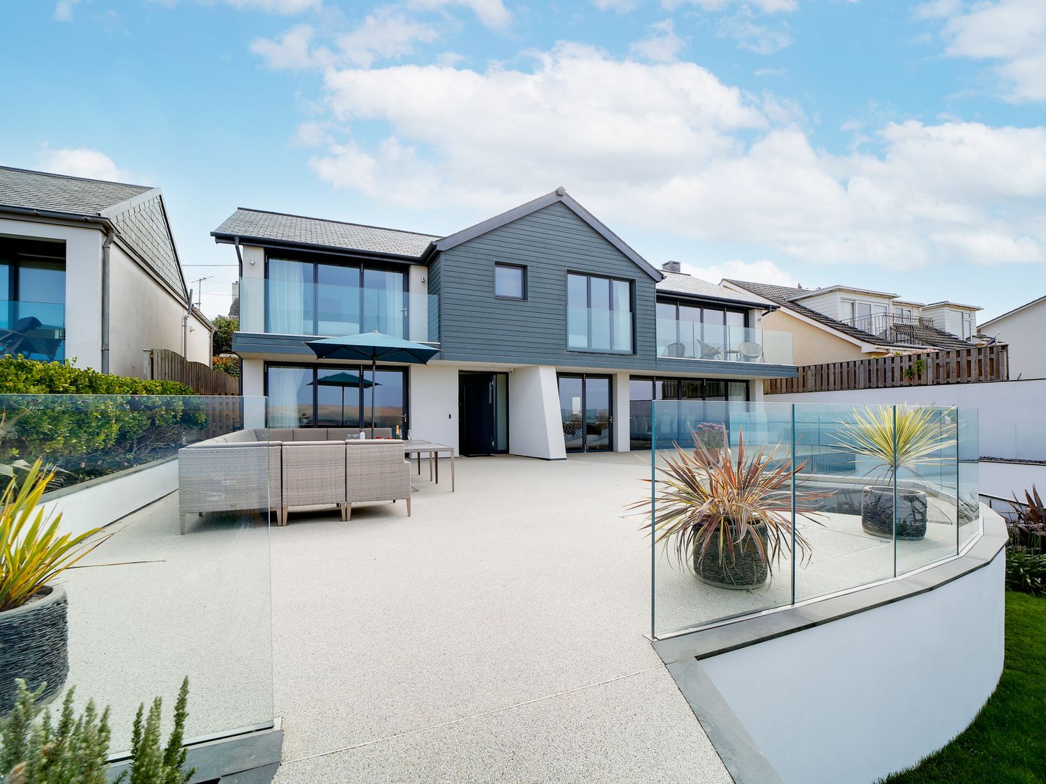 Sea-facing terrace and rear elevation of the MegIzzy coastal home